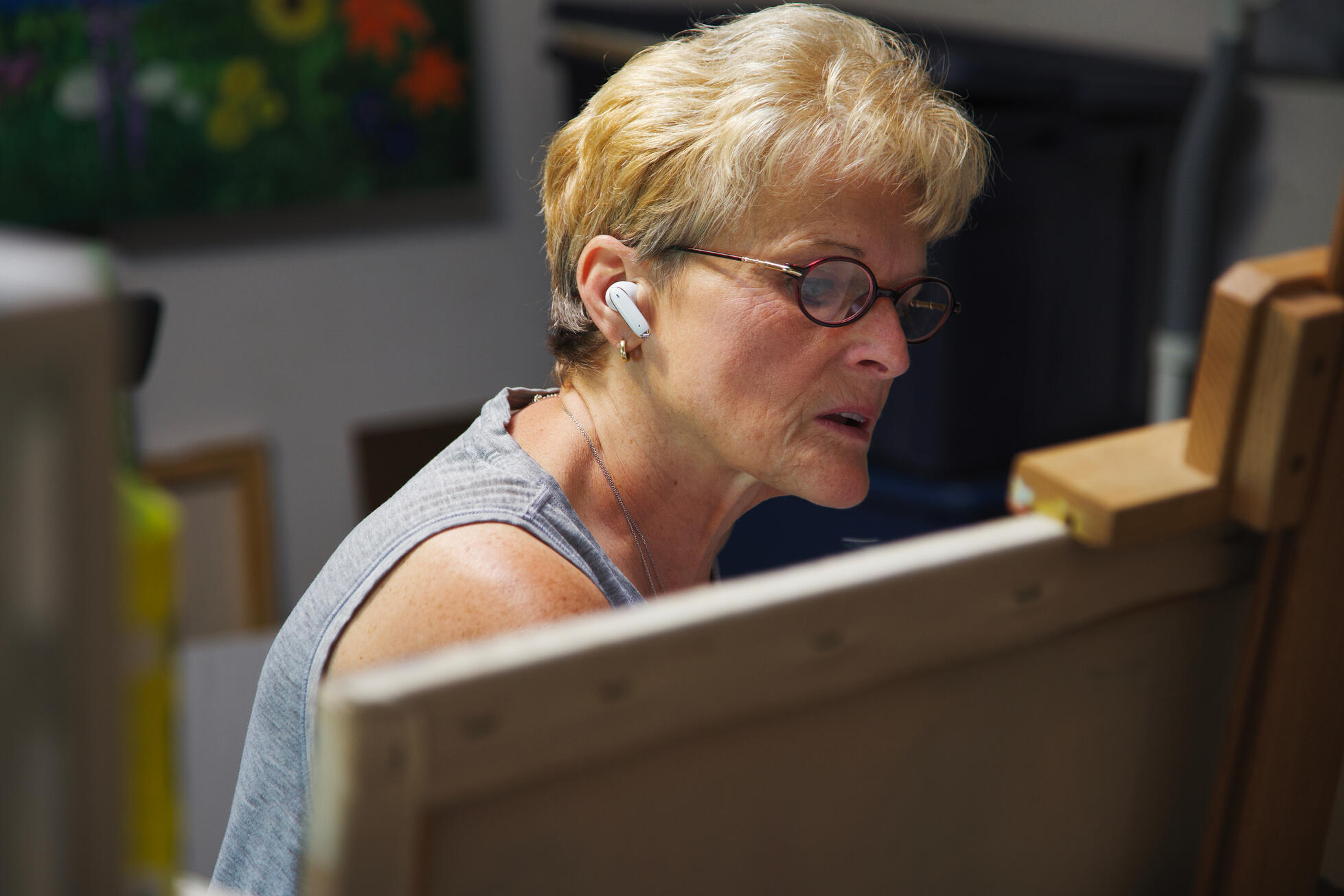 Vermont artist Veronica de Saint Phalle working at her easel in her studio, focused on creating a new painting